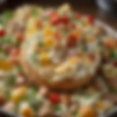 Close-up of the creamy texture of baked loaded potato salad with herbs and toppings.