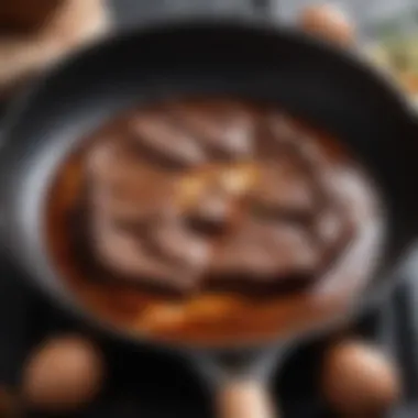 A close-up of sizzling beef fat in a skillet, demonstrating its cooking properties