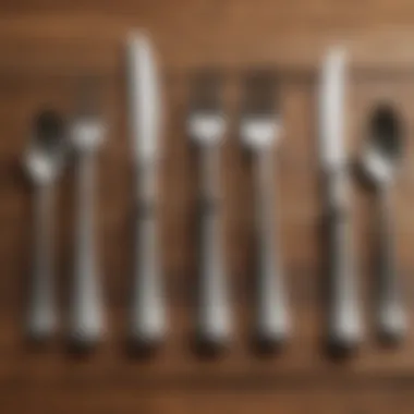 A variety of dinner flatware types displayed on a wooden table