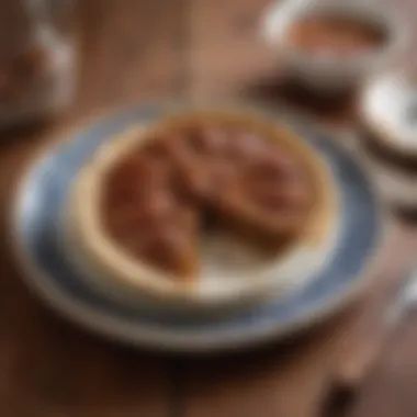 A slice of pecan pie on a decorative plate with a fork beside it