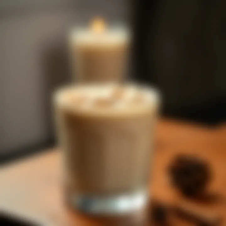 A beautifully garnished glass of coquito topped with cinnamon and coconut flakes