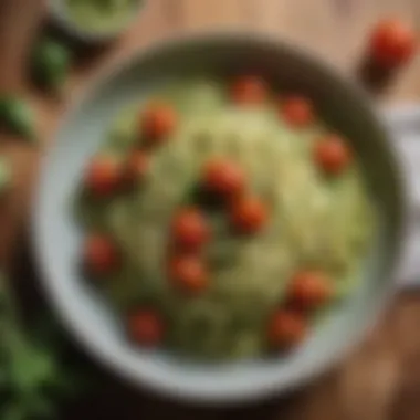 Zucchini noodles topped with fresh pesto and cherry tomatoes