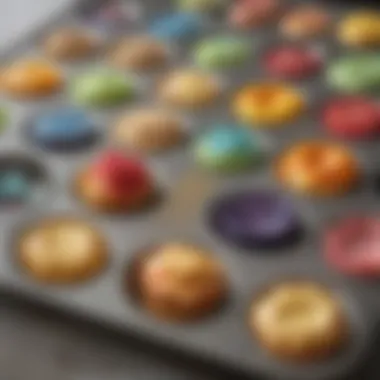 Close-up of a mini muffin pan filled with colorful liners and batter