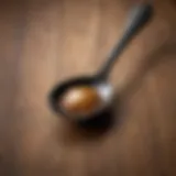 Close-up of a black and tan spoon resting on a wooden surface