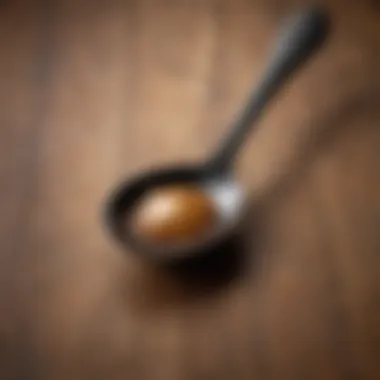 Close-up of a black and tan spoon resting on a wooden surface