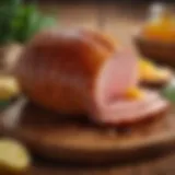 A beautifully glazed honey baked ham on a wooden table.