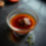 A clear bowl of rich beef consommé showcasing its depth and shine