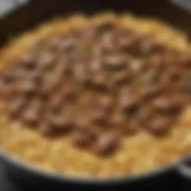 A close-up view of beef stroganoff simmering in a rich sauce