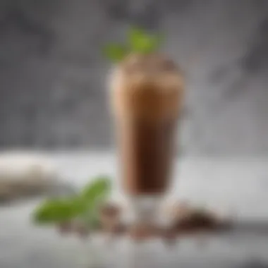 A beautifully crafted iced mocha coffee garnished with mint leaves and chocolate shavings, presented on a marble table.