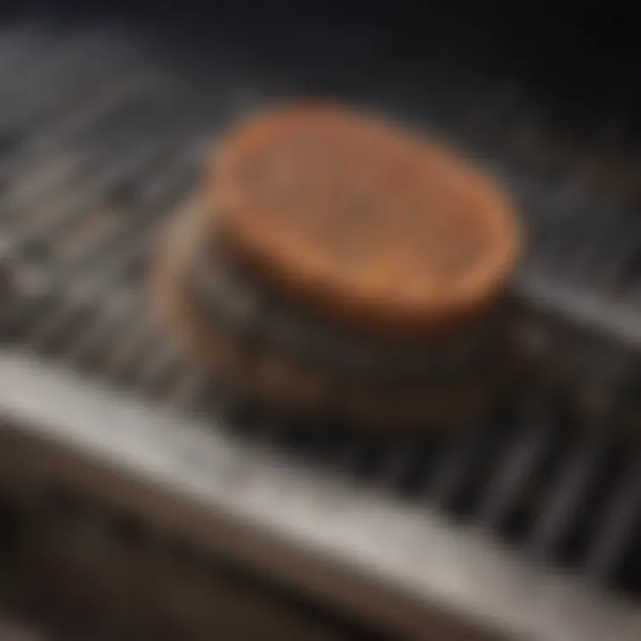 A close-up of a grill brush effectively removing debris from a grate.