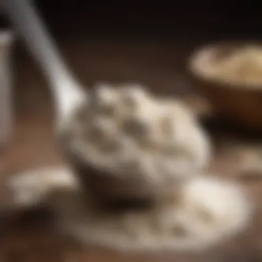 Close-up of a scoop measuring spoon filled with flour against a rustic background.