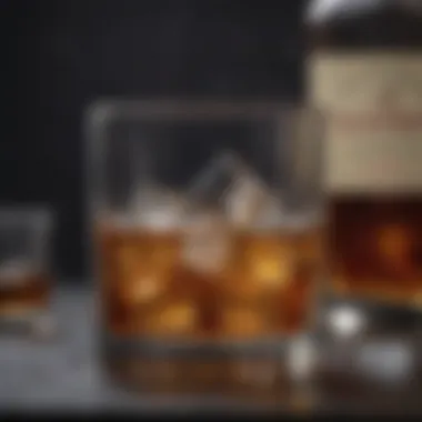 Classic Whiskey on the Rocks A classic glass of whiskey with ice and a twist