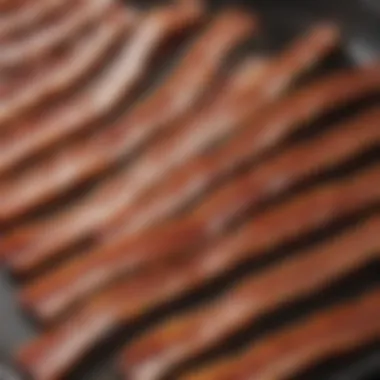 Close-up of crispy bacon strips sizzling in a pan