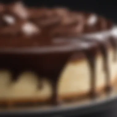 A close-up view of the smooth and glossy chocolate ganache topping on a cheesecake